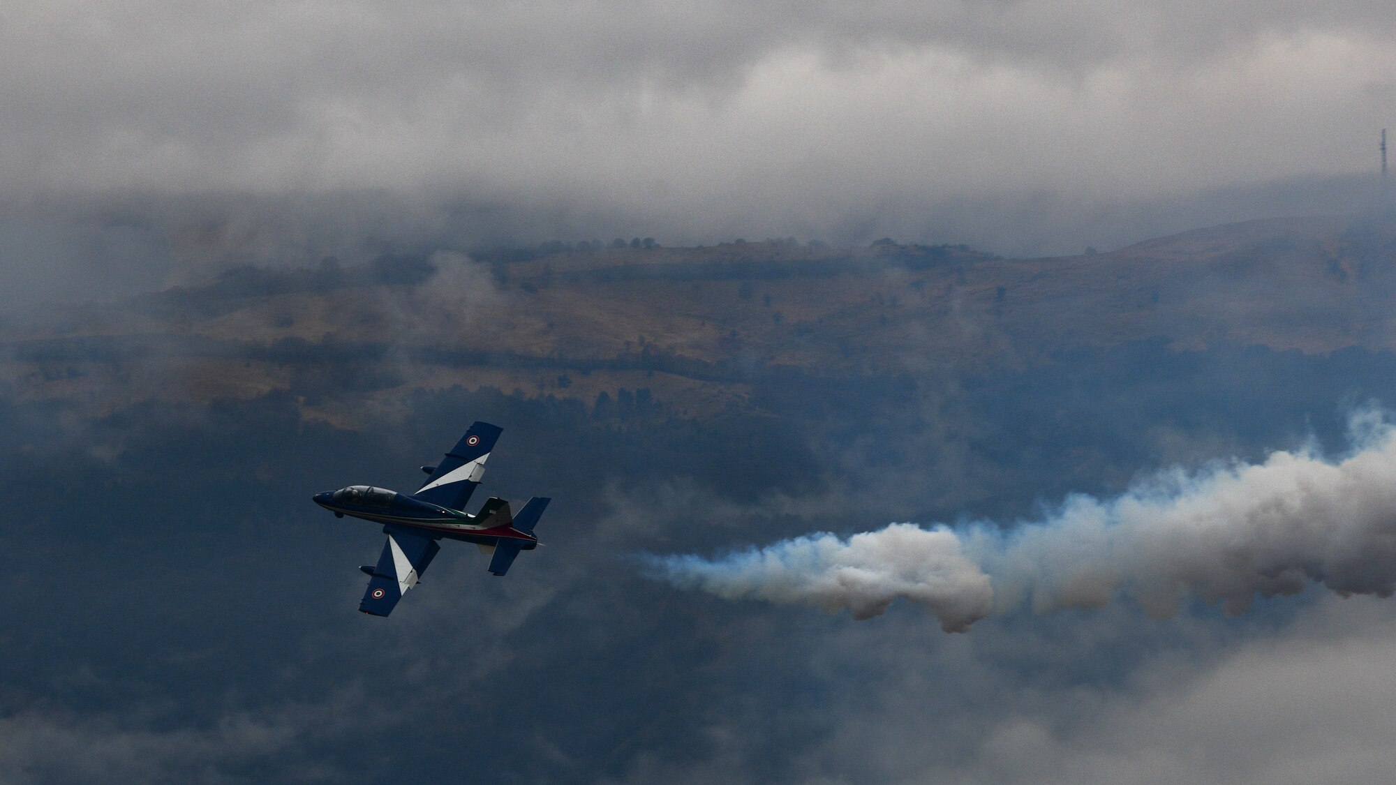 The Frecce Tricolori Italian air force aerobatics team performs expert aerial maneuvers during an open house at Aviano Air Base, Italy, April 1, 2022. The U.S. Air Force and Italian air force organized the demonstration for military children as well as local community school children in honor of the Month of the Military Child. Students viewed a variety of static displays and the Frecce Tricolori Italian air force aerobatics team preformed aerial maneuvers. (U.S. Air Force photo by Senior Airman Brooke Moeder)