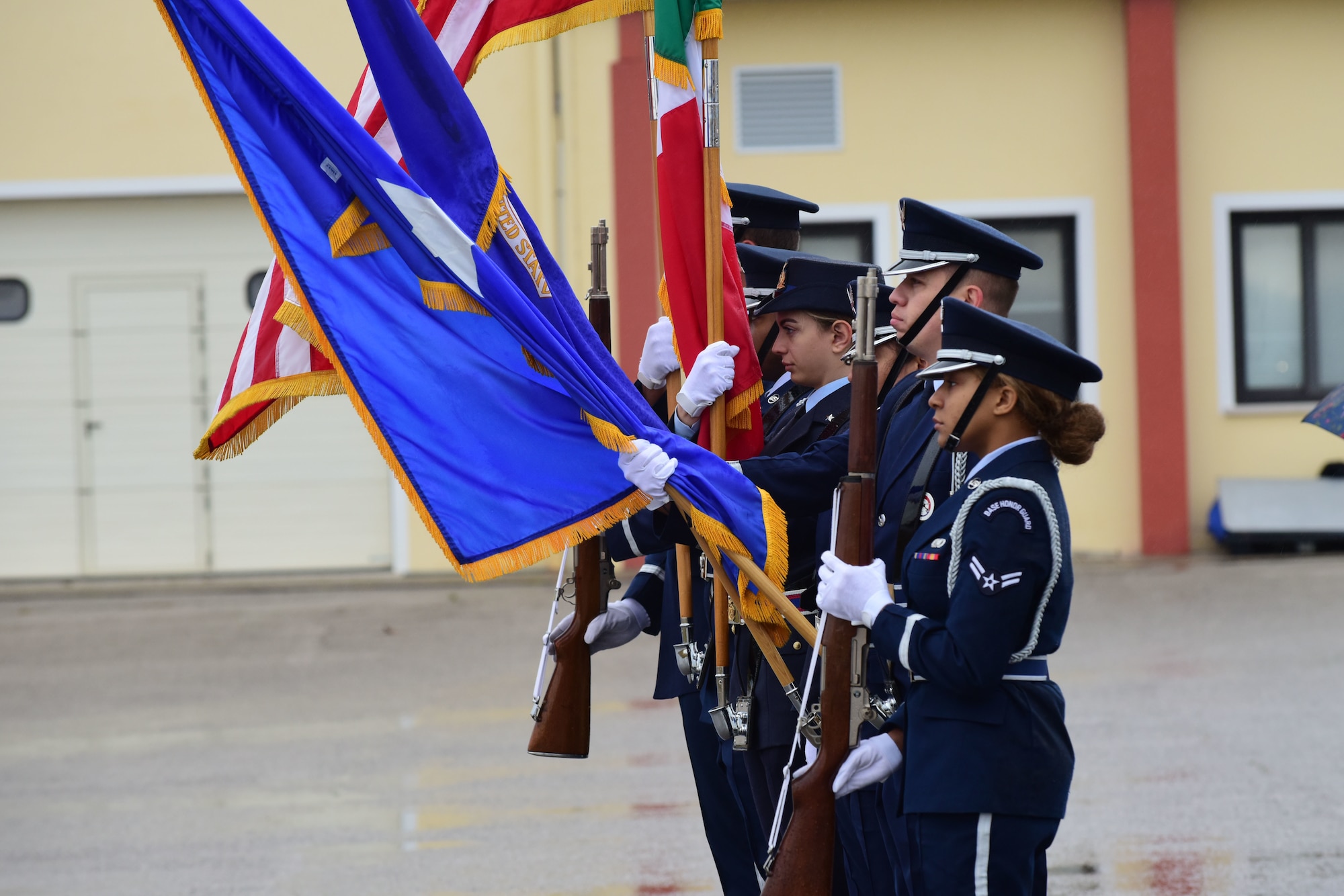 Aviano Air Base’s Honor Guard presents the colors during an open house at Aviano AB, Italy, April 1, 2022. The U.S. Air Force and Italian air force organized the demonstration for military children as well as local community school children in honor of the Month of the Military Child. Students viewed a variety of static displays and the Frecce Tricolori Italian air force aerobatics team performed aerial maneuvers. (U.S. Air Force photo by Senior Airman Jessica Blair)