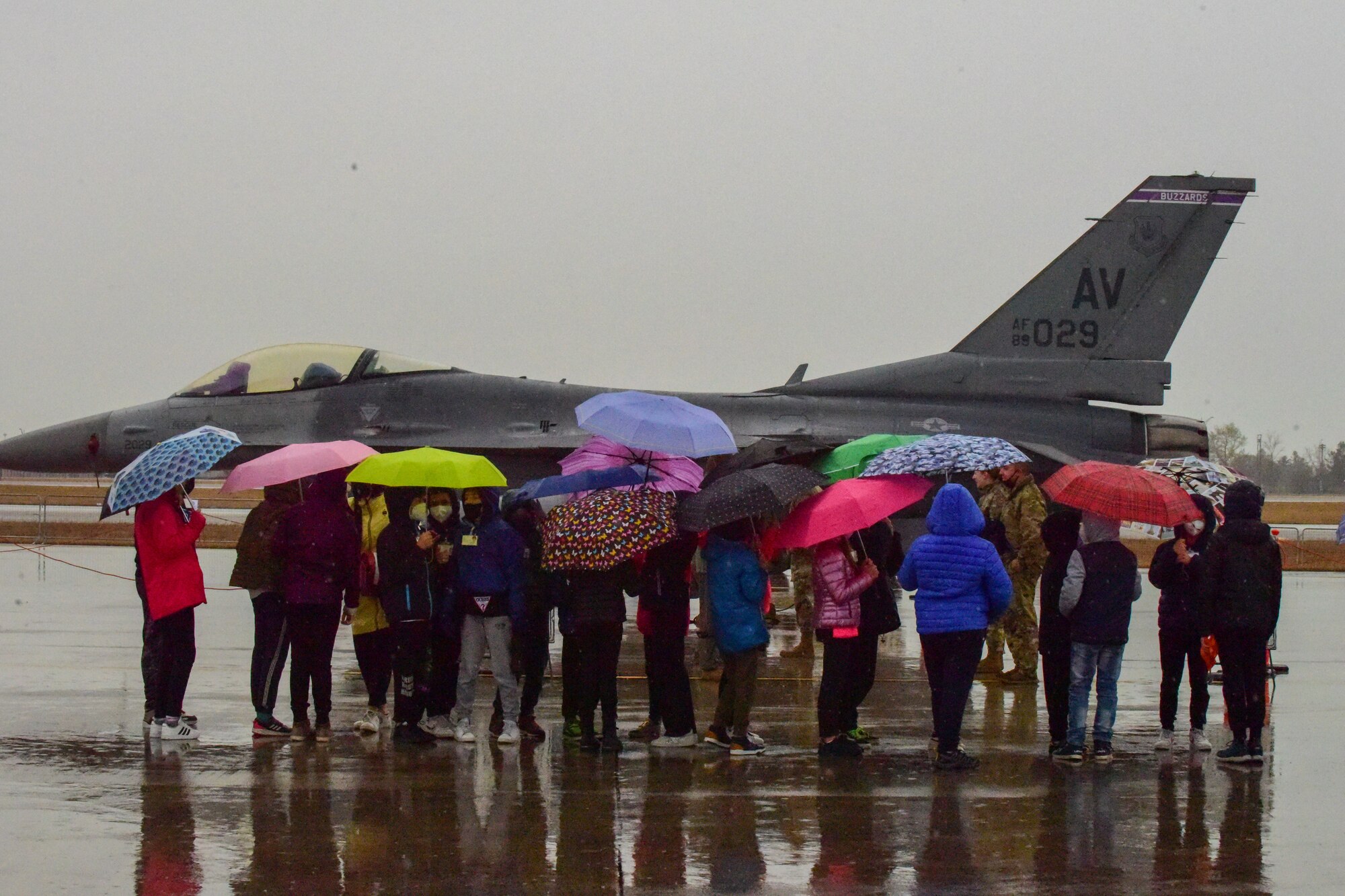 Children view an F-16 Fighting Falcon during an open house at Aviano Air Base, Italy, April 1, 2022. The U.S. Air Force and Italian air force organized the demonstration for military children as well as local community school children in honor of the Month of the Military Child. Students viewed a variety of static displays and the Frecce Tricolori Italian air force aerobatics team performed aerial maneuvers. (U.S. Air Force photo by Senior Airman Jessica Blair)