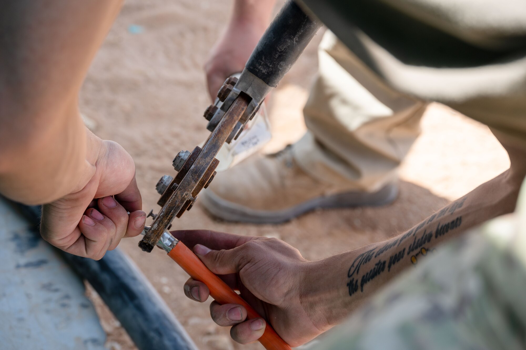 332d Expeditionary Civil Engineer Squadron Airmen crimp an electrical cable during a backup generator install at an undisclosed location in Southwest Asia, March 28, 2022. The 332d ECES provides, operates, and maintains a sustainable installation through engineering and emergency response services across the full mission spectrum. (U.S Air Force photo by Tech. Sgt. Lauren M. Snyder)