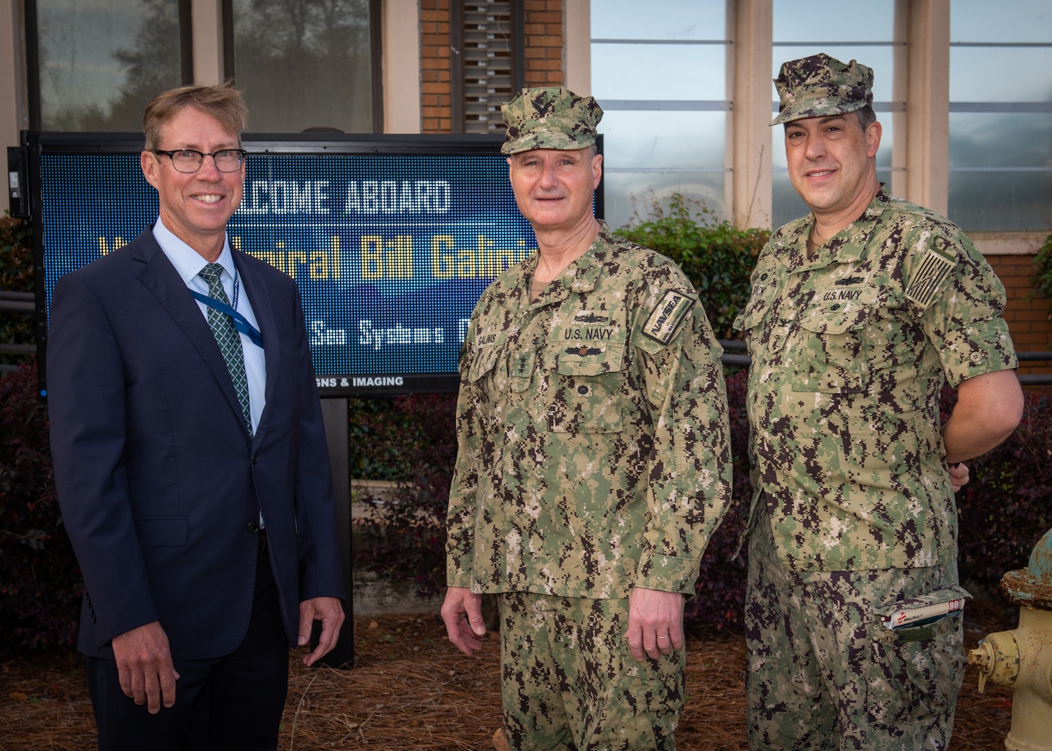 (left) Dr. Peter Adair, Naval Surface Warfare Center Panama City Division technical director, and (right) Capt. David Back, NSWC PCD commanding officer welcome Commander of Naval Sea Systems Command (NAVSEA), Vice Adm. Bill Galinis during his visit, March 30. Galinis experienced Panama City’s reputation as the home of military diving through presentations of diving systems NSWC PCD develops and supports for Naval Special Warfare, Explosive Ordnance Disposal, Specialized Research Diving Detachment, Special Operations Command, and Navy Diving. (U.S. Navy photo by Eddie Green)