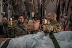 U.S. Air Force Lt. Col. Christopher Lane, director of operations for the 137th Aeromedical Evacuation Squadron, speaks to doctors with the Azerbaijan Operational Capabilities Concept Battalion about aeromedical evacuation roles during a medical knowledge exchange event in Oklahoma City March 30, 2022. The knowledge exchange involved the participation and support of Guardsmen with both the Oklahoma Army and Air National Guard in support of the State Partnership Program.