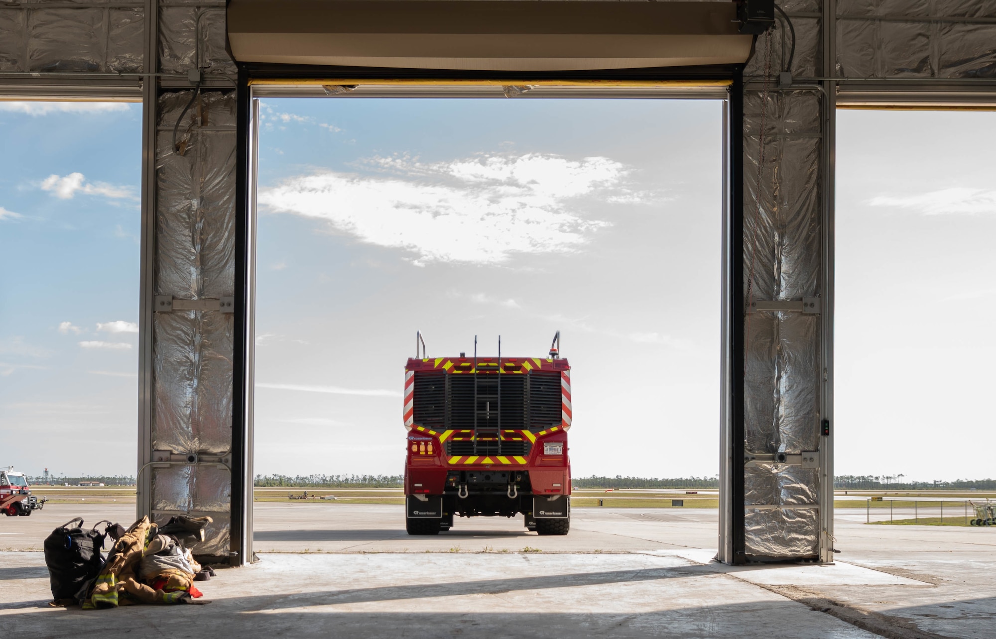 A fire truck sits outside of a Bay.