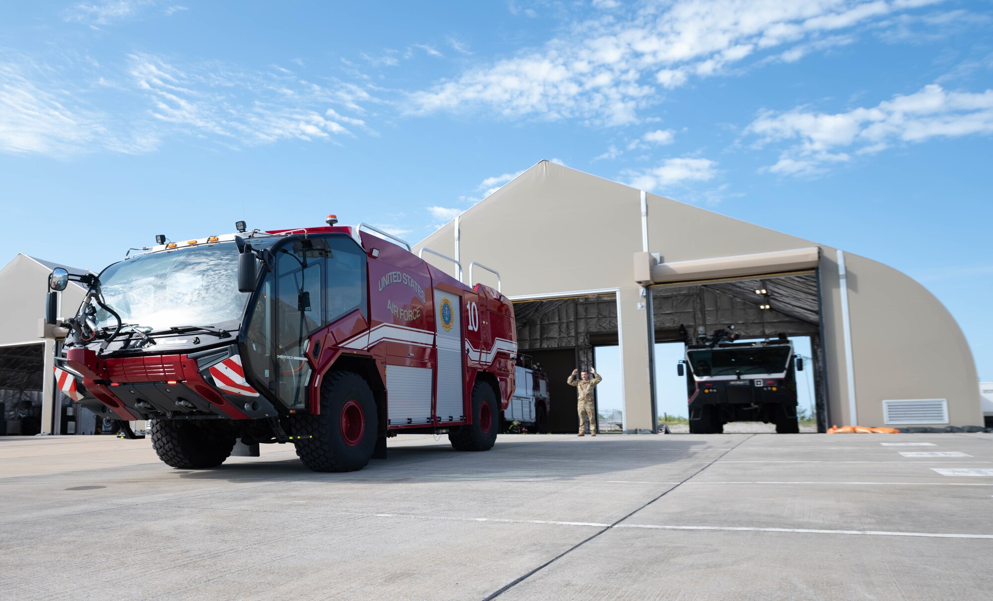 A firetruck is parked outside of a bay.