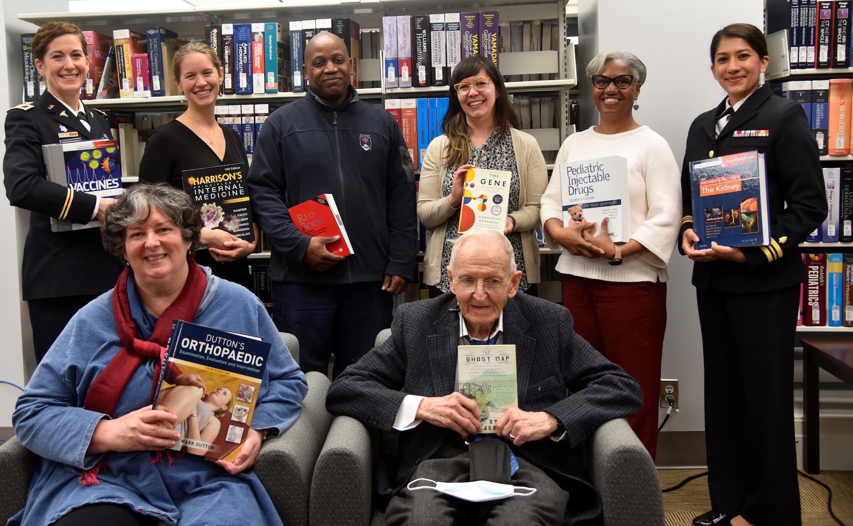 Staff of the Darnall Medical Library of the Walter Reed National Military Medical Center pose for a group photo in the Darnall Medical Library, March 30, 2022.. The library was awarded the 2022 Research Advancement Award by the Medical Library Association for their support to medical research and evidence based medical services.