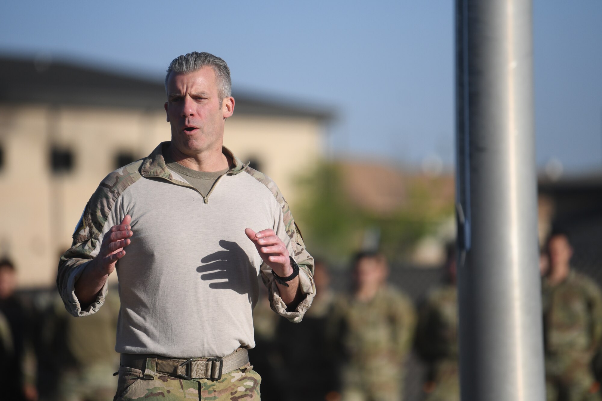 U.S. Air Force Chief Master Sgt. Todd Popovic, Special Warfare Training Wing command chief, gives a motivational and historical perspective speech during a rededication ceremony in honor of U.S. Air Force Lt. Col. William Schroeder and U.S. Air Force Staff Sgt. Scott Sather at the SWTW training compound Joint Base San Antonio, Chapman Training Annex, Apr. 8, 2022.  The wing and echelon units hosted a two and one-half mile ruck march followed by Memorial pushups and the unveiling of refitted memorials in coordination with Gold Star families (U.S. Air Force photo by Brian Boisvert)