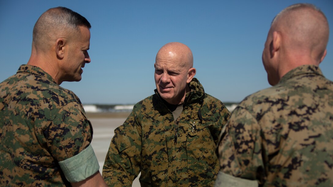 U.S. Marine Corps Gen. David Berger, commandant of the Marine Corps, speaks with Brig. Gen. Andrew Niebel (Left) and Col. Curtis Ebitz (right) on Marine Corps Air Station New River, North Carolina, March 28, 2022.