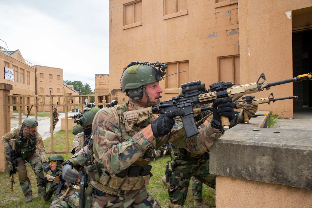 Dutch Marines with Marine Squadron Carib receive simulated enemy fire during a Movement on Urban Terrain training exercise, Camp Lejeune, N.C., March 31, 2022.