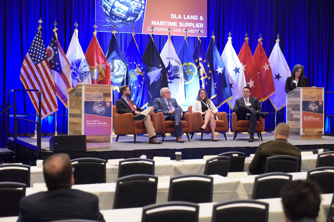 Panel of people on stage.