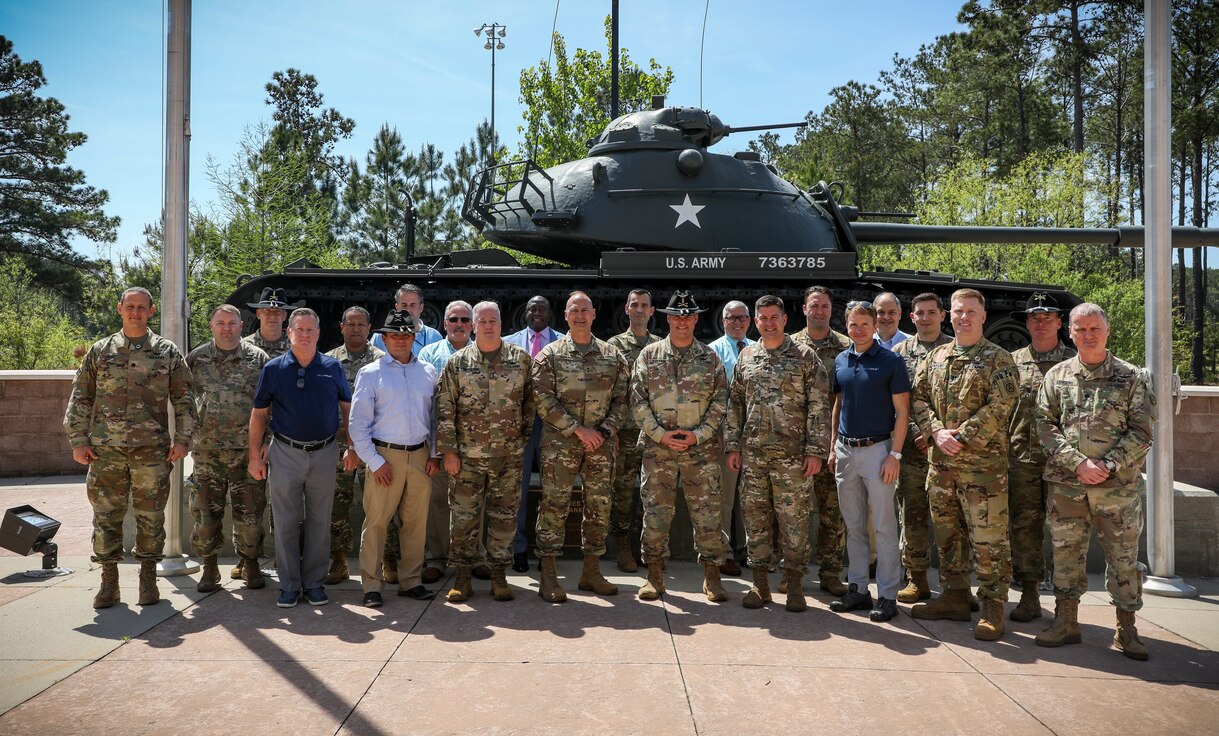 Current and former Army Aviation members pose in front of U.S. Army Central HQ, along with ARCENT's Deputy Commanding General, MG Wendul Hagler II.