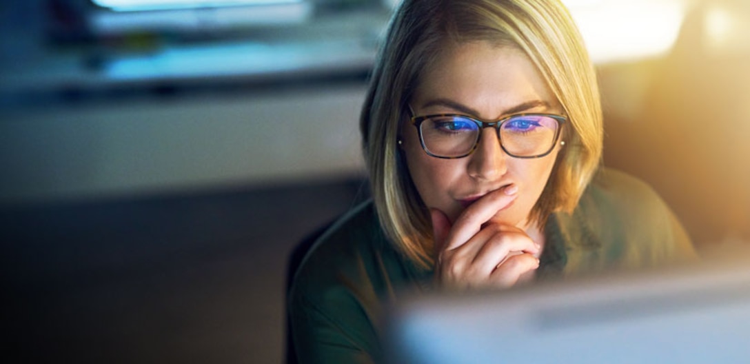 Lady looking intently at a computer screen.