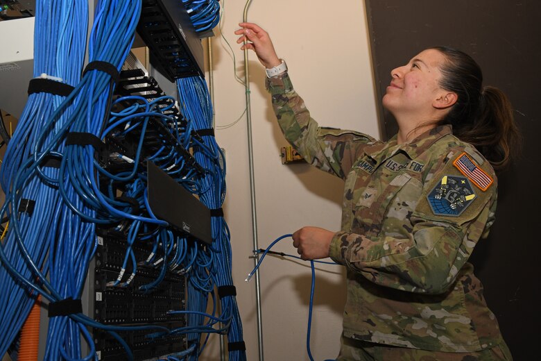 SCHRIEVER SPACE FORCE BASE, Colo. – U.S. Space Force Spc. 4 Aileen Ocampo, 50th Communications Squadron network infrastructure technician, patches a switch from the network to an individual port on Schriever Space Force Base, April 11, 2022. The 50th SCS manages and ensures network connectivity for all personnel on SSFB. (U.S. Space Force photo by Airman 1st Class Aaron Edwards)