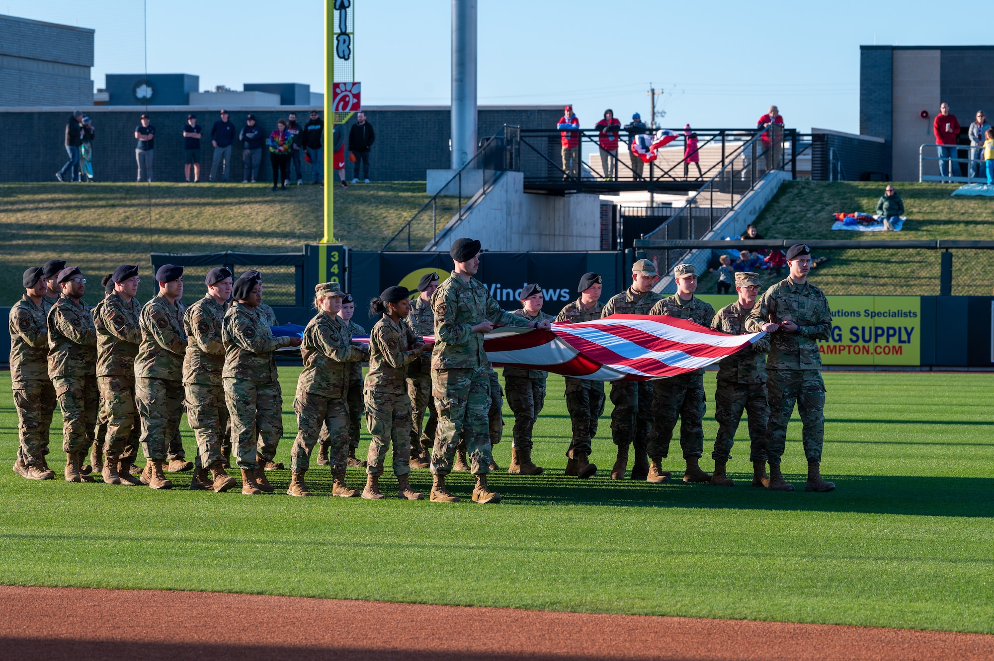 Airmen from the 22nd Air Refueling Wing, McConnell Air Force Base, Kansas, present an American flag for the national anthem April 8, 2022, at Riverfront Stadium in Wichita, Kansas. McConnell’s