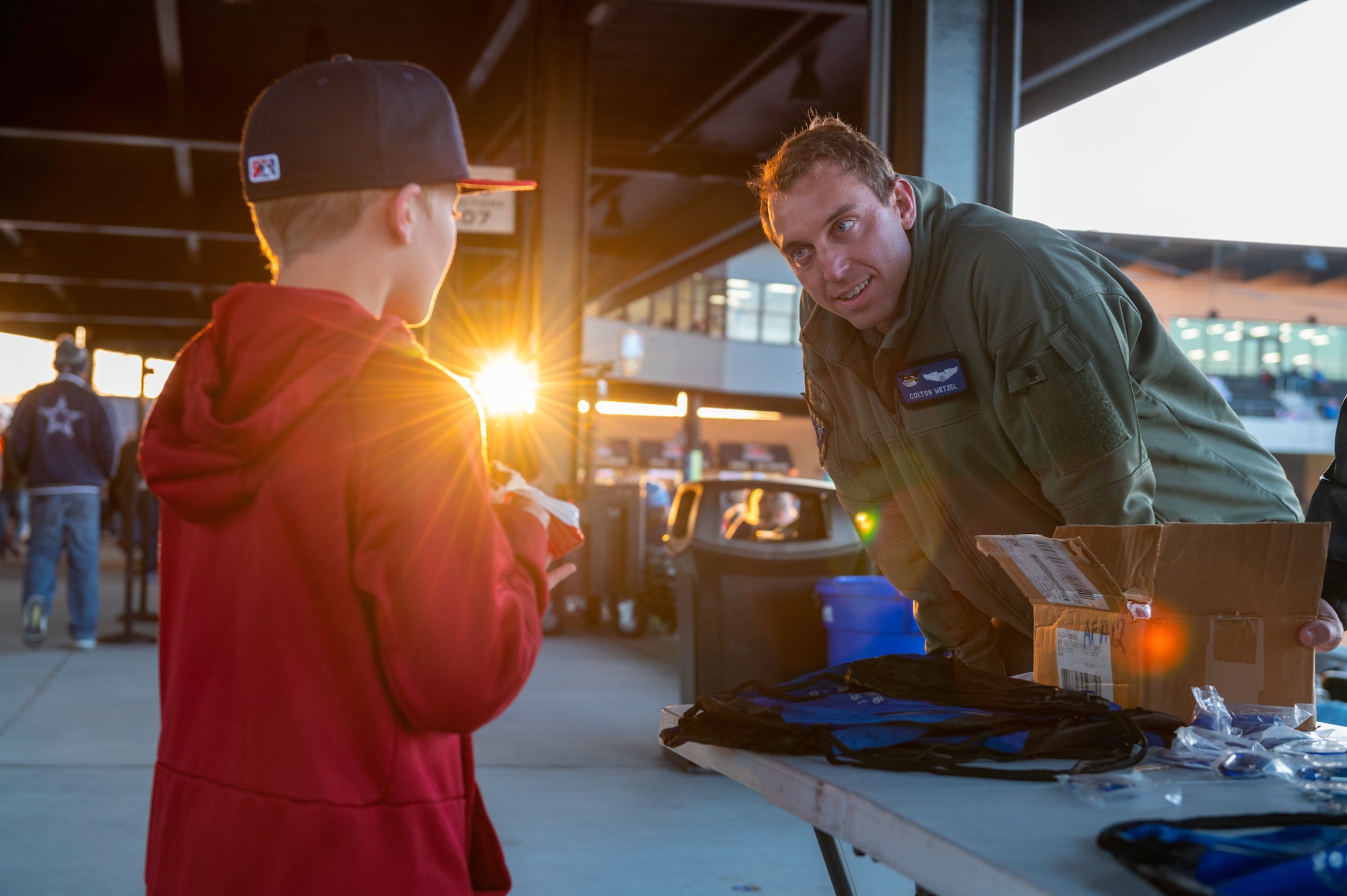 Captain Colton Wetzel, 22nd Air Refueling Wing Aviation Inspiration Mentorship wing program director, talks with a Wichita Wind Surge fan about what it’s like being an Air Force pilot, April 8, 2022, at Riverfront Stadium in Wichita, Kansas.