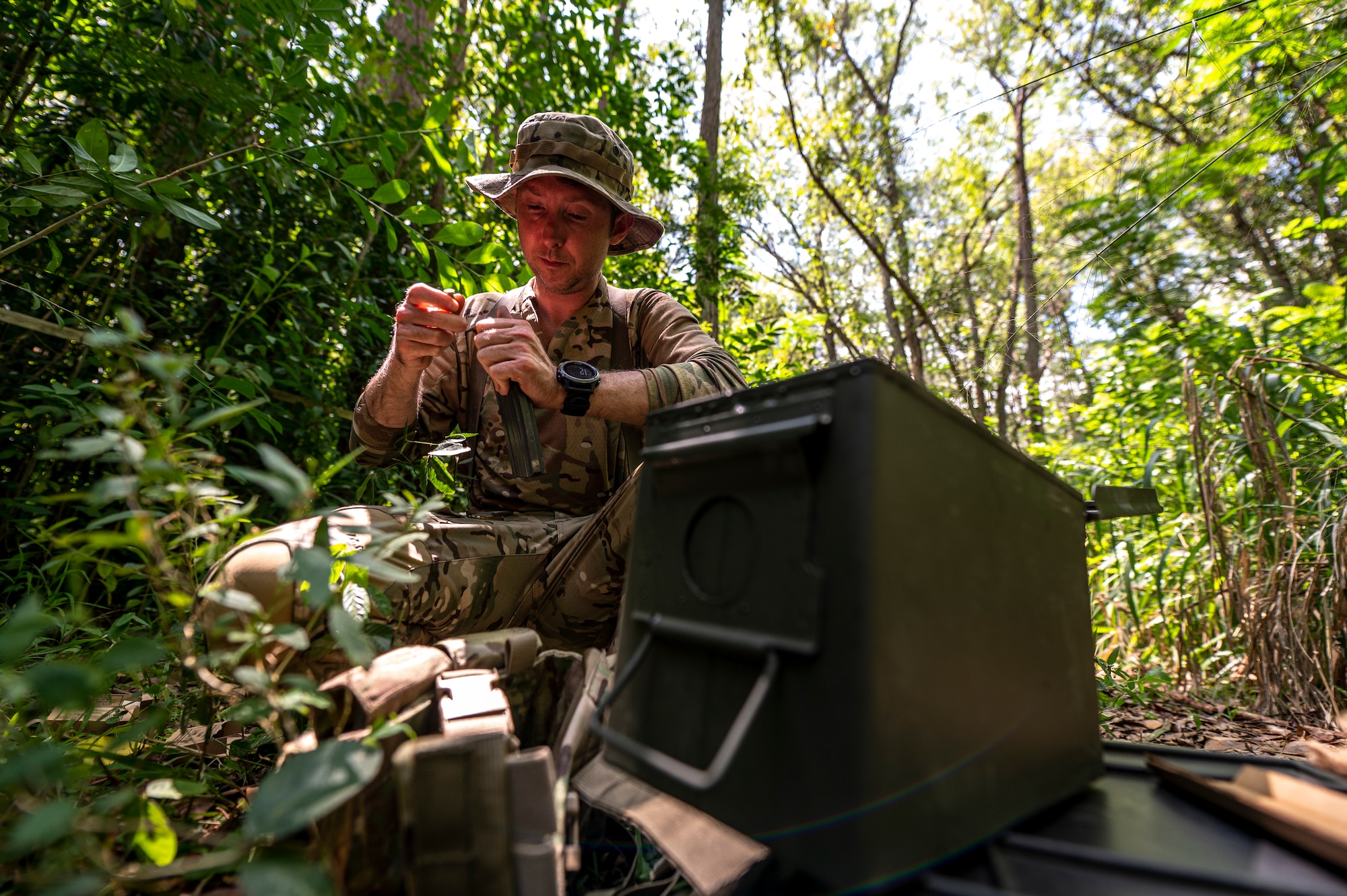 Photo of Airman filling magazines with ammo