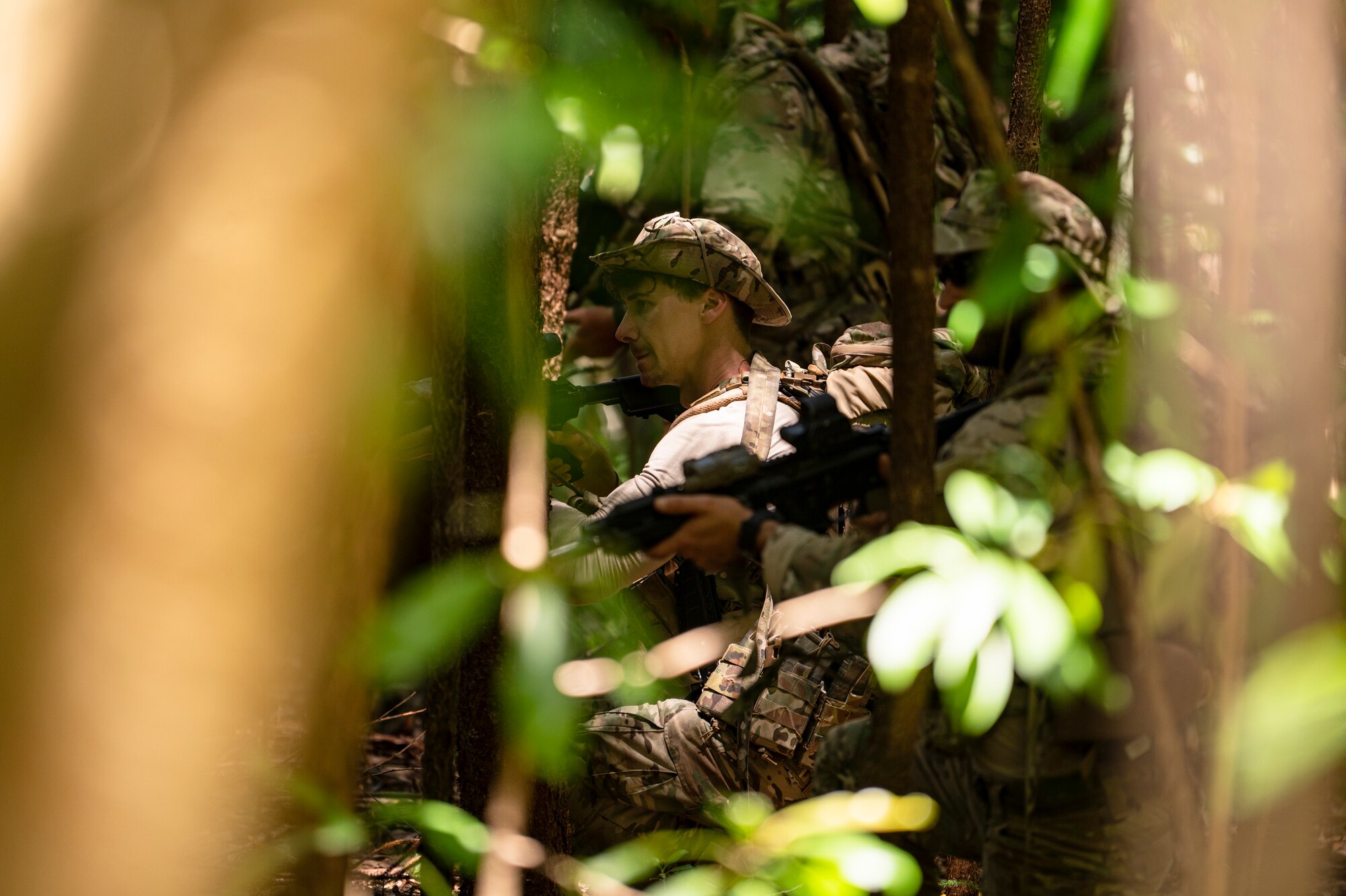 Photo of Airman walking through the jungle