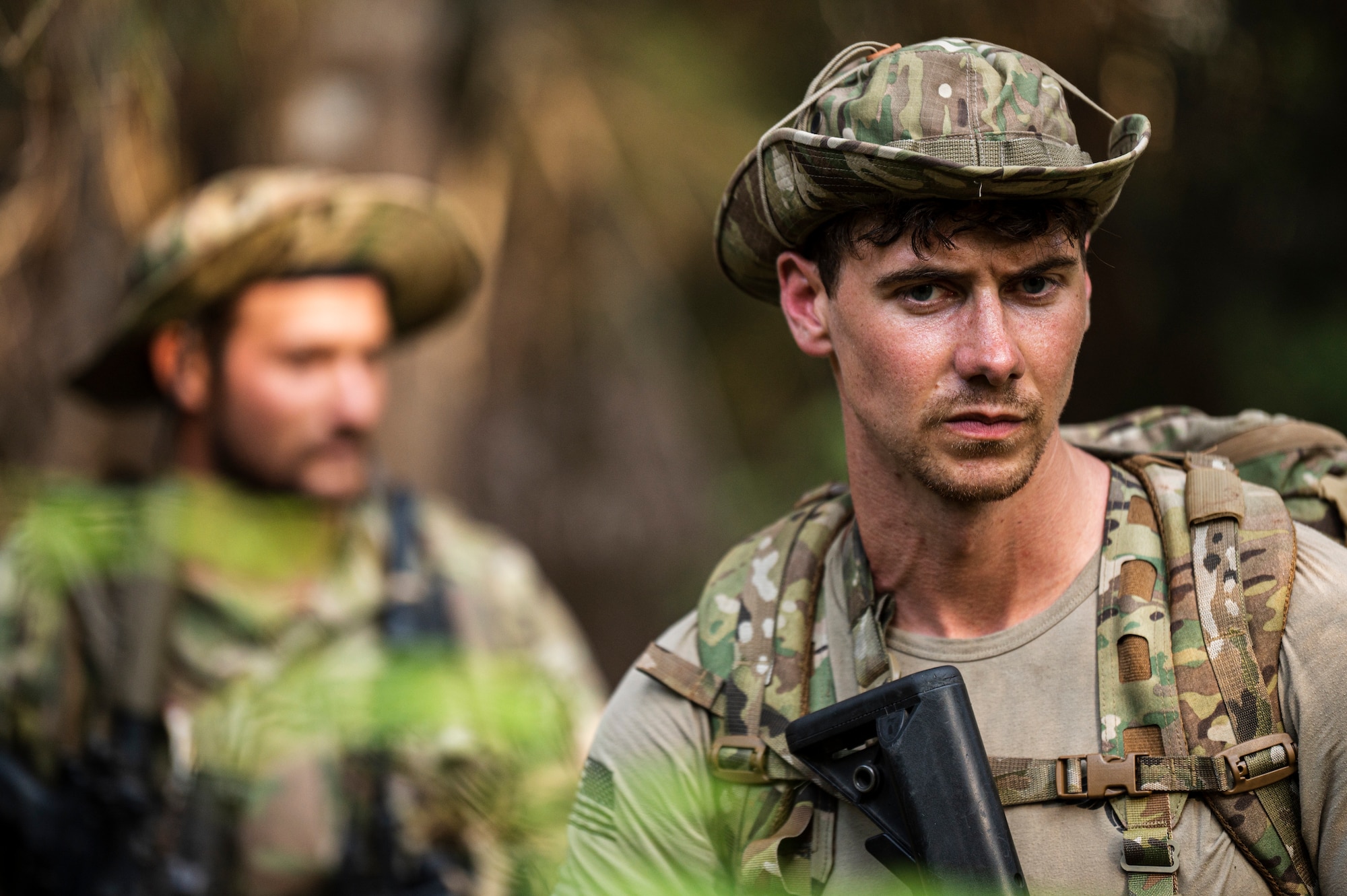 Photo of Airmen walking through the jungle