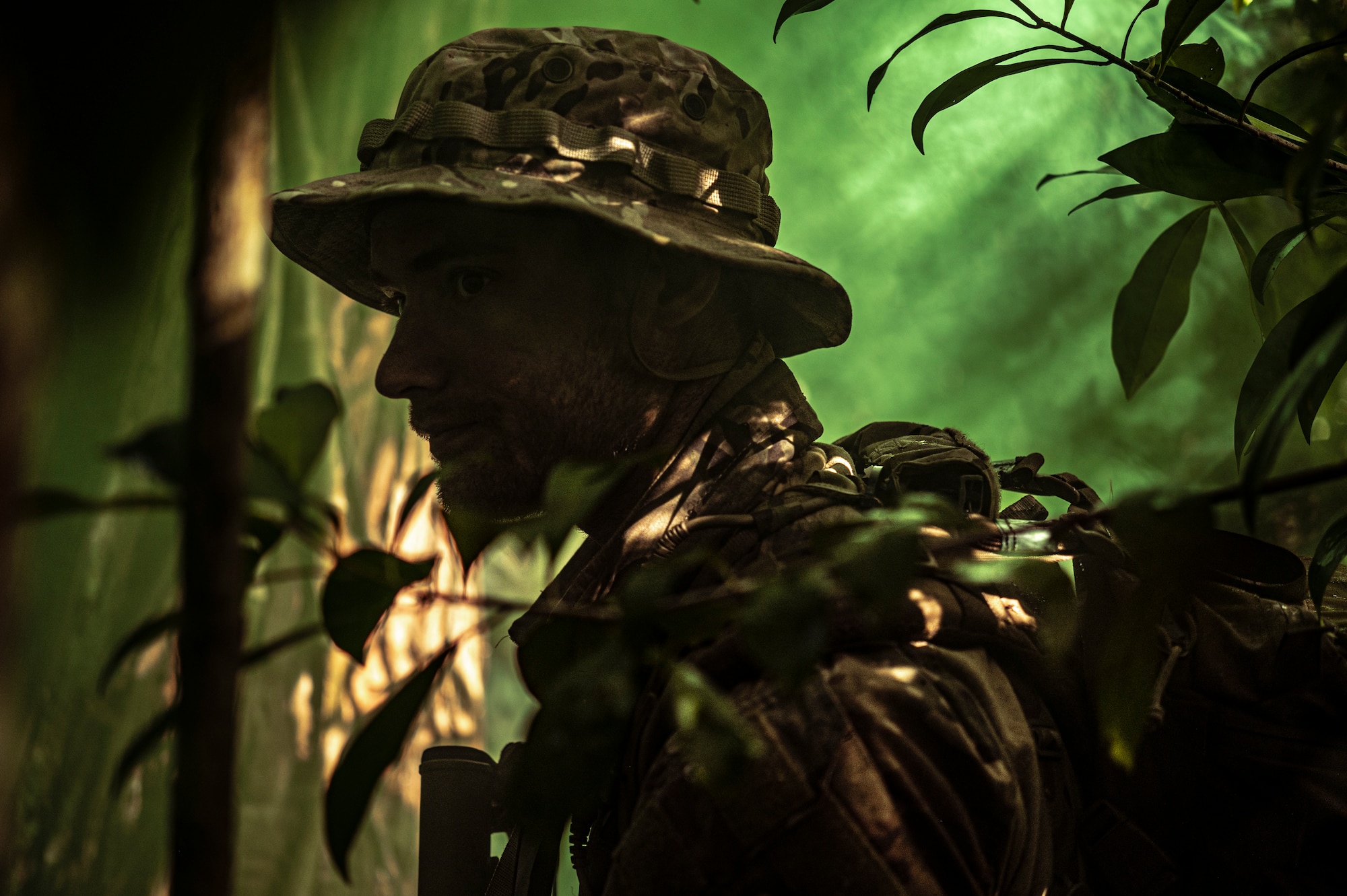 Photo of Airman walking through the jungle