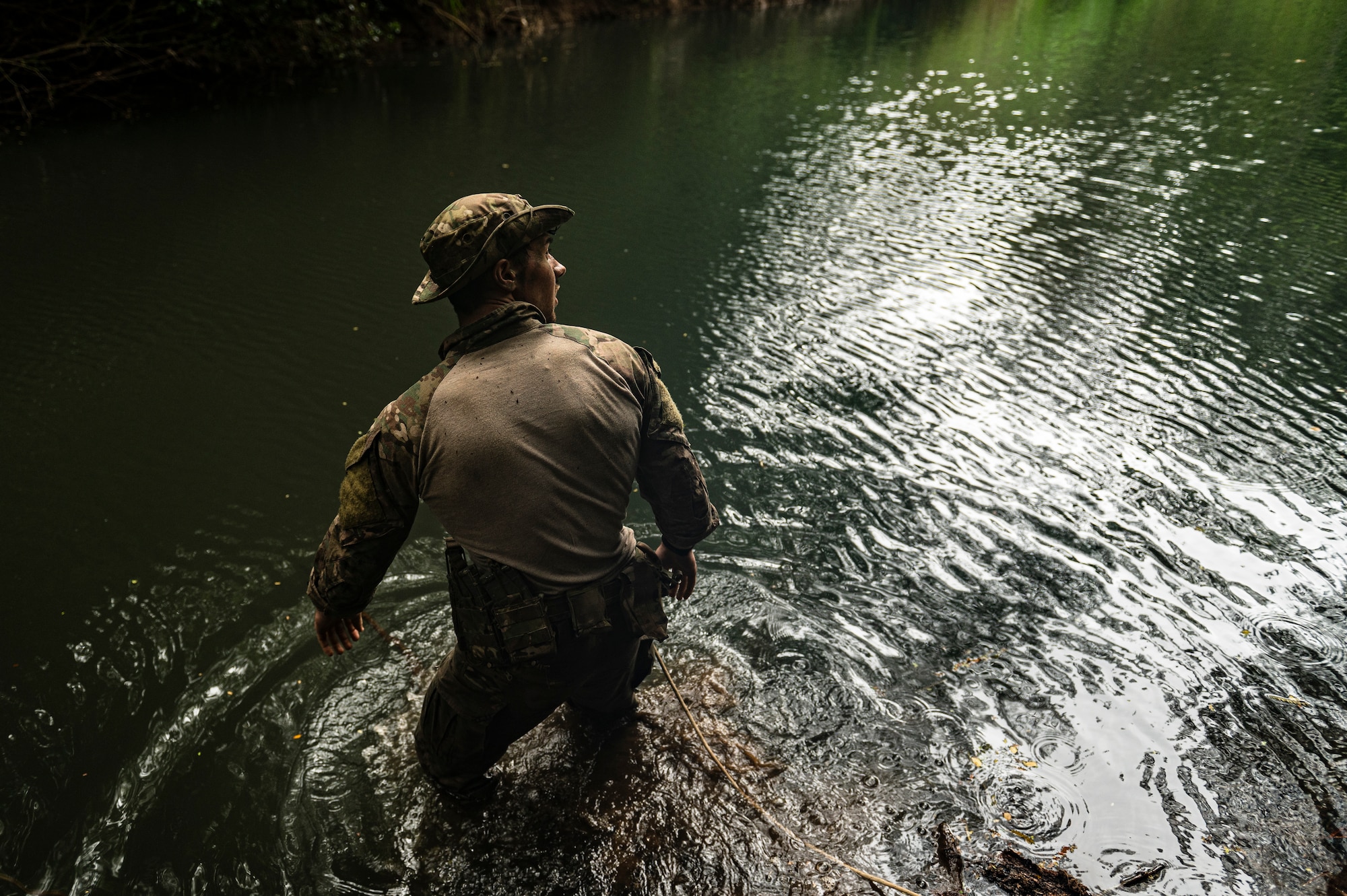 Photo of Airman walking through water