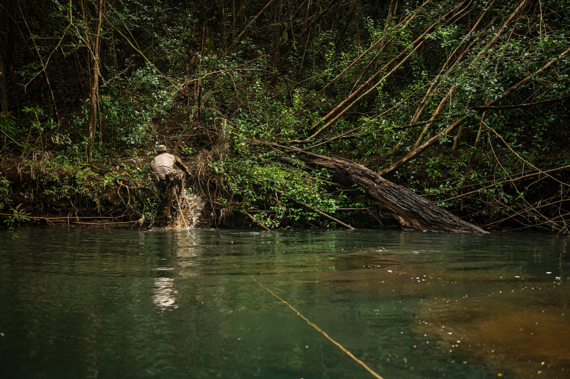 Photo of Airman walking through water