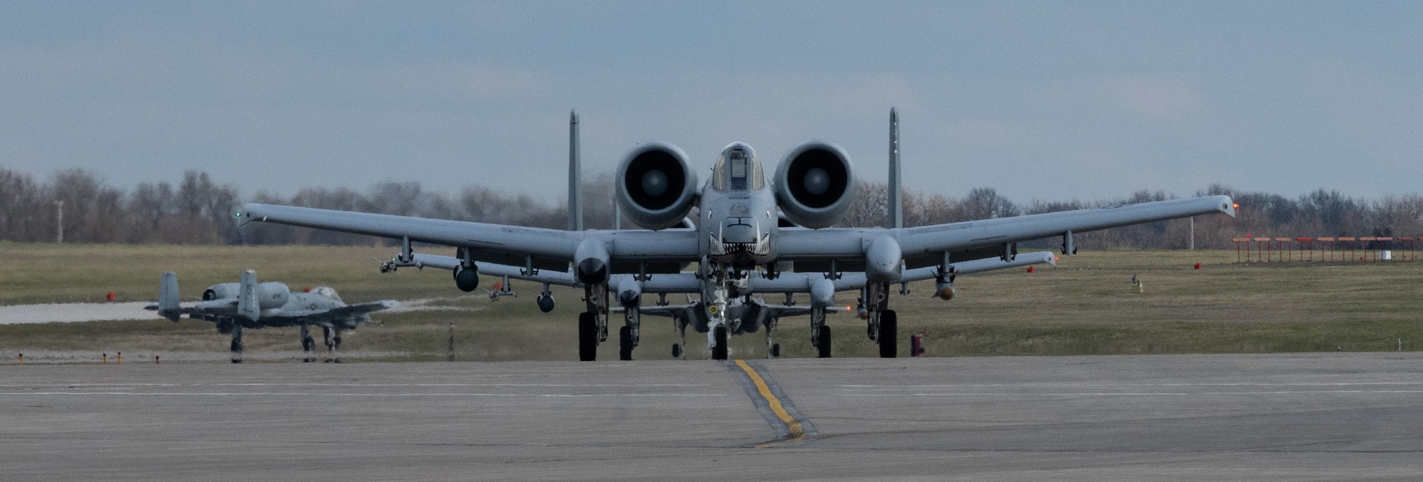 Three A-10 Thunderbolts and an F-35 Lightning taxi during Exercise Agile Tiger on Whiteman Air Force Base, Missouri April 5, 2022. Exercise Agile Tiger tests the joint force that we can posture, equip, sustain, move and maneuver, and command and control deliberately trained Airman across a network of bases to complicate adversary targeting, preserve combat power, and fight from a position of advantage. (U.S. Air Force photo by Airman 1st Class Bryson Britt)