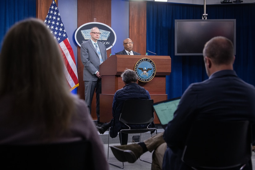 Two men stand behind a lectern.