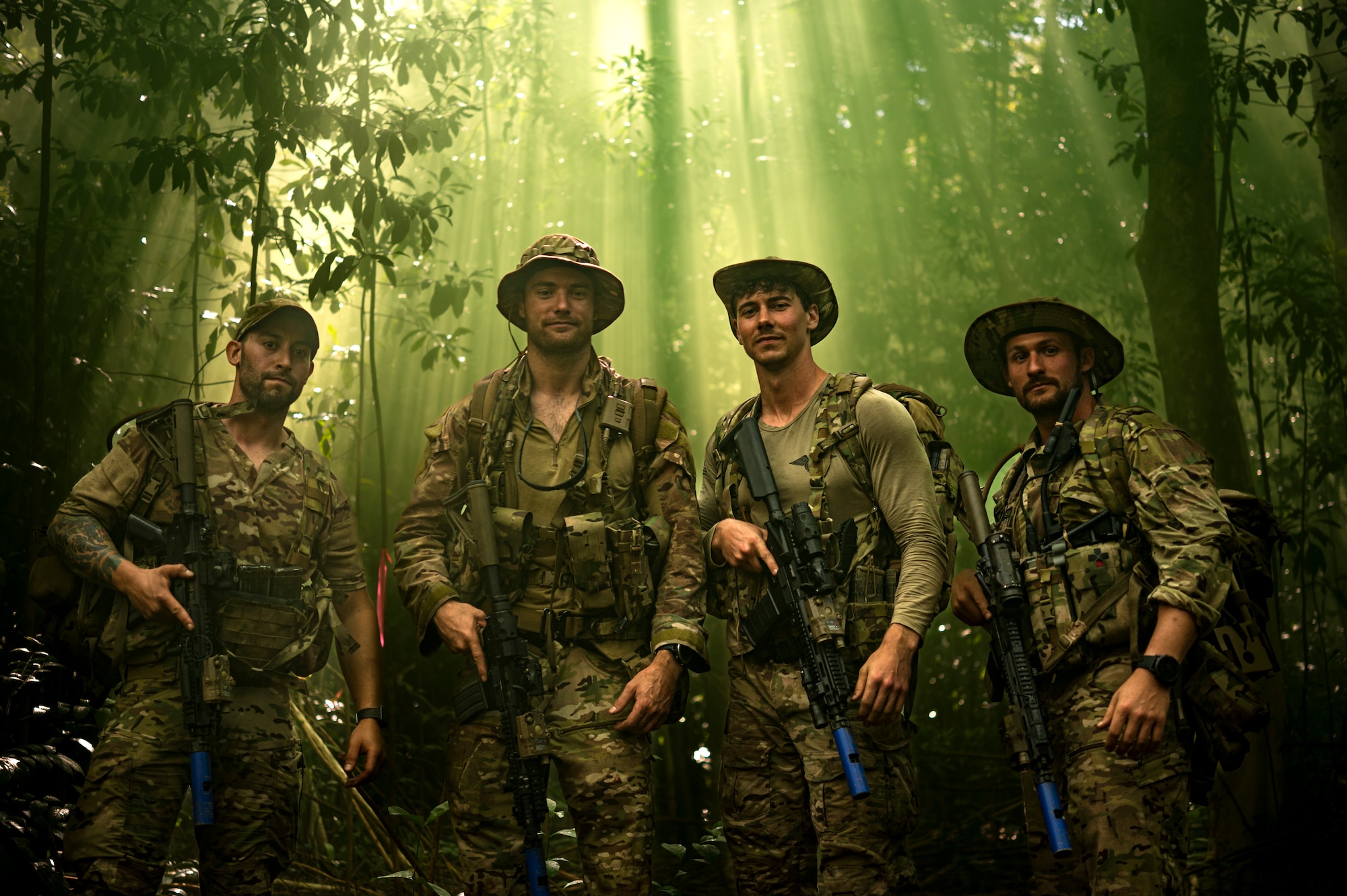 Photo of Airmen standing in the jungle