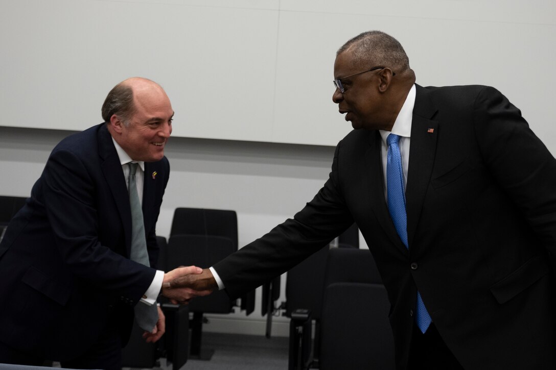 Secretary of Defense Lloyd J. Austin III shakes hands with British Secretary of State for Defence Ben Wallace.