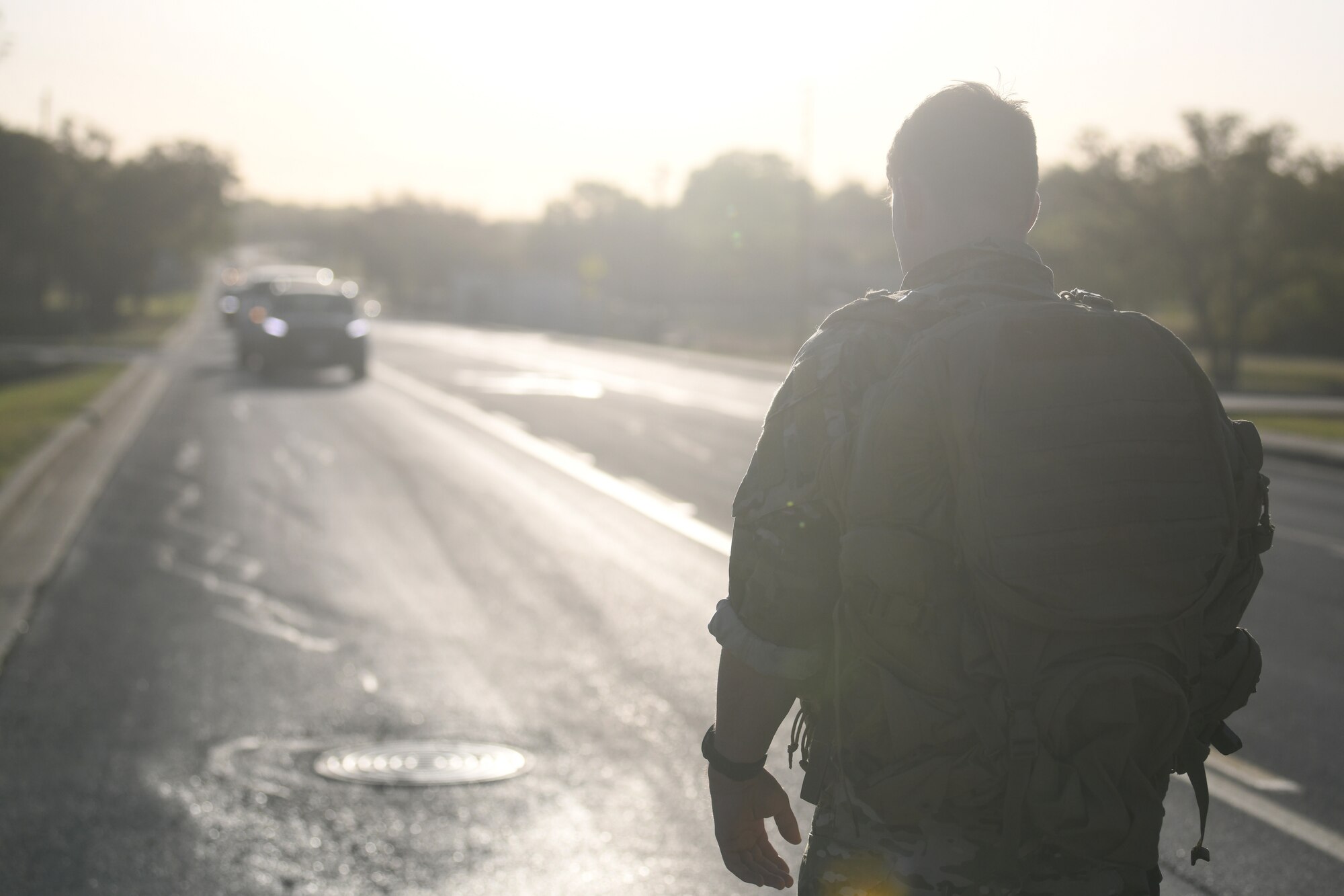 Special Warfare Trainees stop traffic during the Special Warfare Training Wing rededication ceremony in honor of U.S. Air Force Lt. Col. William Schroeder and U.S. Air Force Staff Sgt. Scott Sather at the SWTW training compound Joint Base San Antonio, Chapman Training Annex, Apr. 8, 2022. The wing hosted a two and one-half mile ruck march followed by Memorial pushups and the unveiling of refitted memorials in coordination with Gold Star families.  (U.S. Air Force photo by Brian Boisvert)