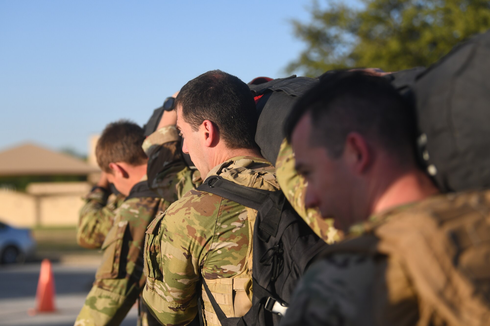 Special Warfare Trainees participate in the Special Warfare Training Wing rededication ceremony in honor of U.S. Air Force Lt. Col. William Schroeder and U.S. Air Force Staff Sgt. Scott Sather at the SWTW training compound Joint Base San Antonio, Chapman Training Annex, Apr. 8, 2022. The wing hosted a two and one-half mile ruck march followed by Memorial pushups and the unveiling of refitted memorials in coordination with Gold Star families.  (U.S. Air Force photo by Brian Boisvert)