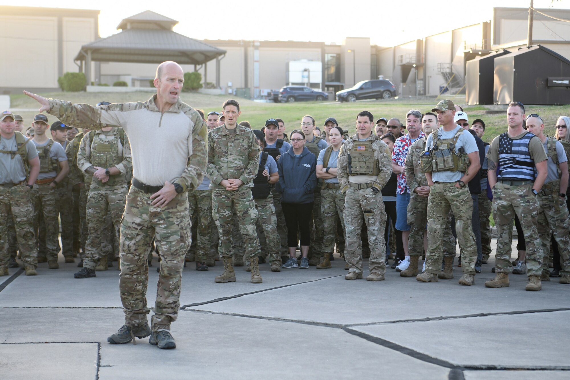 U.S. Air Force Col. Mason Dula, Special Warfare Training Wing commander, discusses the sequence of events and safety procedures prior to a two and one-half mile ruck march during a rededication ceremony in honor of U.S. Air Force Lt. Col. William Schroeder and U.S. Air Force Staff Sgt. Scott Sather at the SWTW training compound Joint Base San Antonio, Chapman Training Annex, Apr. 8, 2022.  The wing and echelon units hosted a two and one-half mile ruck march followed by Memorial pushups and the unveiling of refitted memorials in coordination with Gold Star families (U.S. Air Force photo by Brian Boisvert)