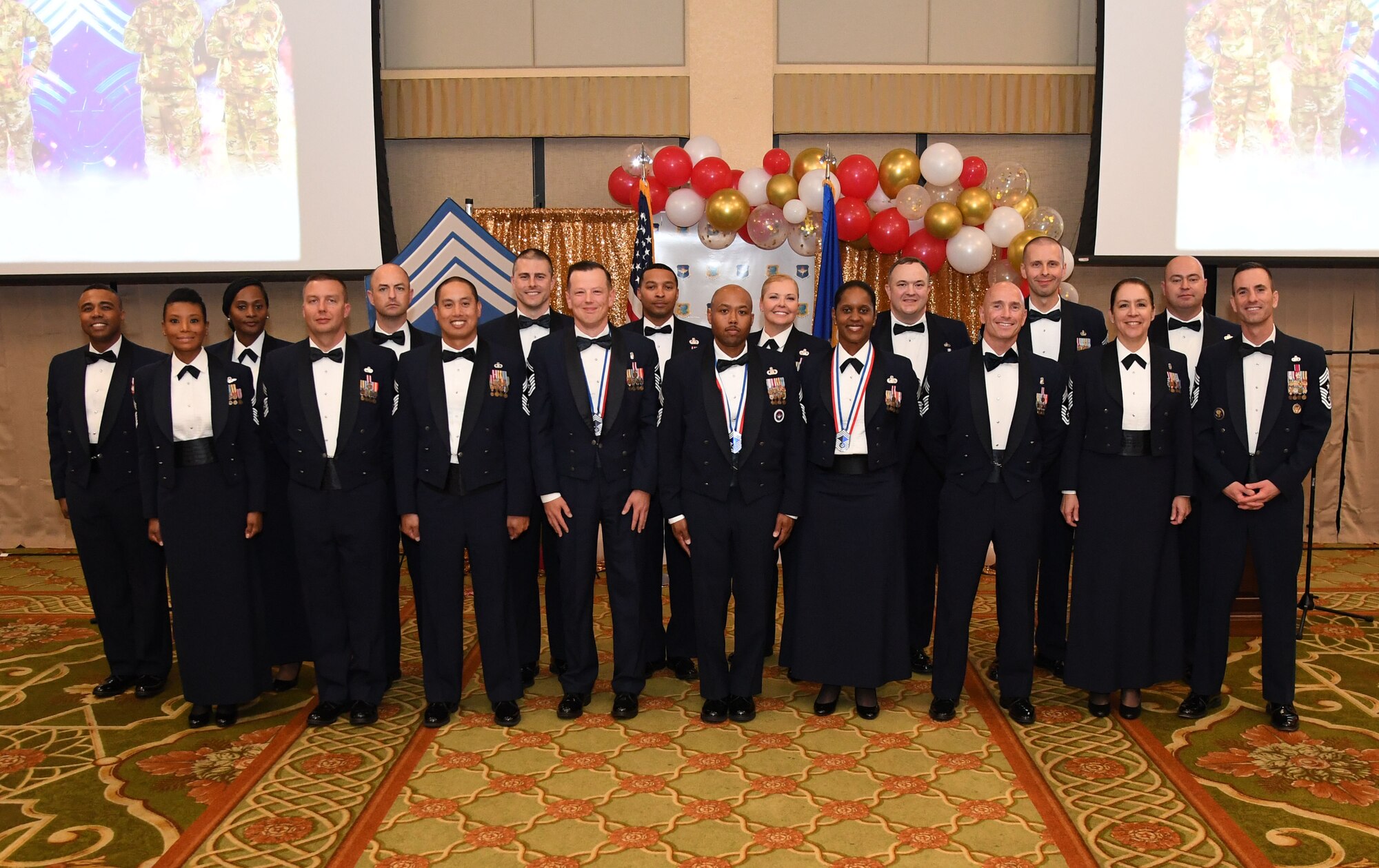 Recently inducted and current Keesler chief master sergeants pose for a photo during the Chief Master Sergeant Recognition Ceremony inside the Bay Breeze Event Center at Keesler Air Force Base, Mississippi, April 8, 2022. Four Keesler Airmen earned their chief master sergeant stripe during the 2022 promotion release. Chief master sergeants make up one percent of the Air Force enlisted force. (U.S. Air Force photo by Kemberly Groue)