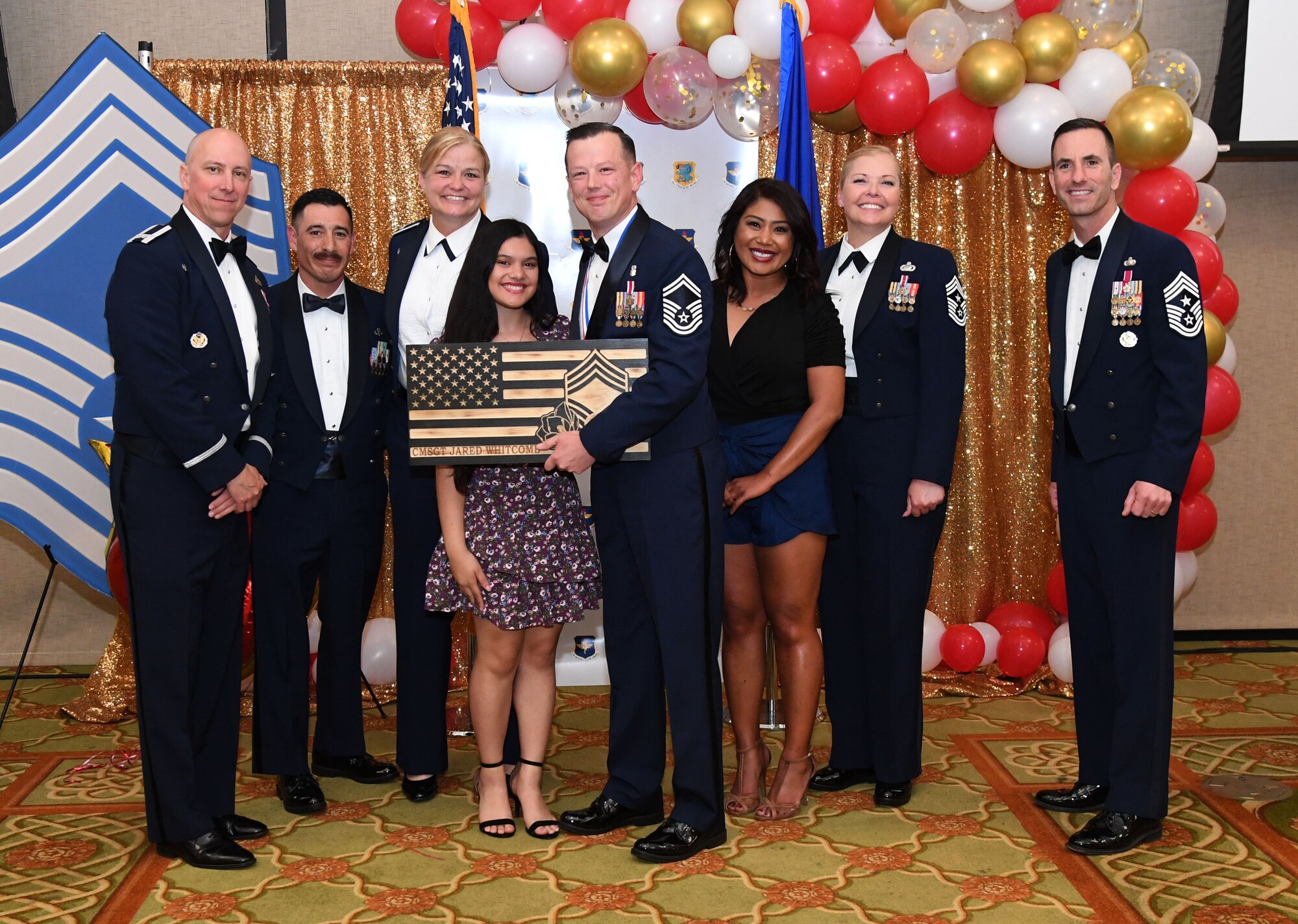 U.S. Air Force Senior Master Sgt. Jared Whitcomb, 81st Healthcare Operations Squadron senior enlisted leader, poses for a photo with his family during the Chief Master Sergeant Recognition Ceremony inside the Bay Breeze Event Center at Keesler Air Force Base, Mississippi, April 8, 2022. Four Keesler Airmen earned their chief master sergeant stripe during the 2022 promotion release. Chief master sergeants make up one percent of the Air Force enlisted force. (U.S. Air Force photo by Kemberly Groue)