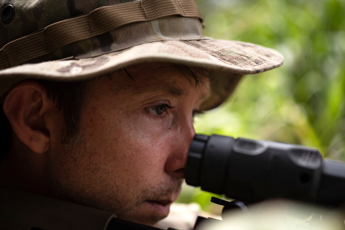 Photo of Airman looking down scope