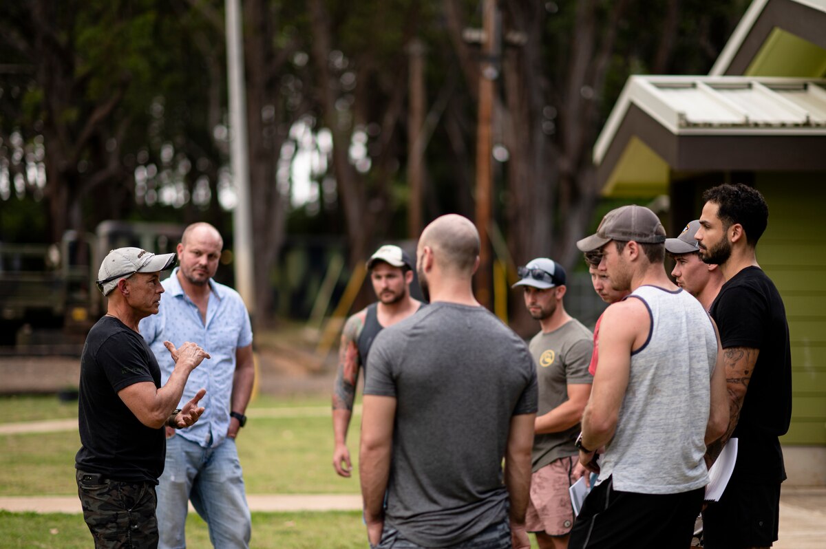 Photo of Airmen standing outdoors