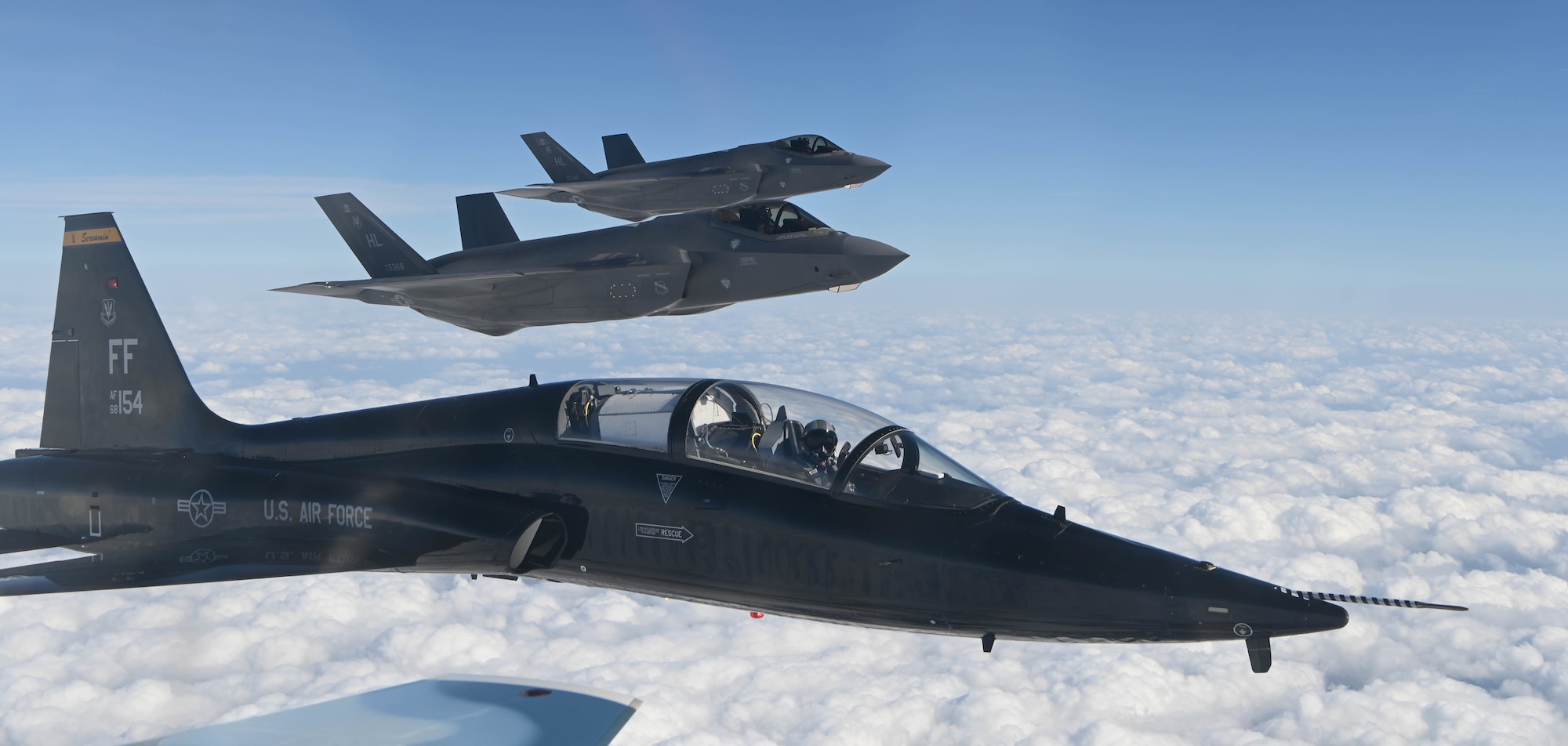 U.S. Air Force T-38 Talon and two F-35 Lightning II's fly in formation over Whiteman Air Force Base, Missouri, April 5, 2022. The flying was to demonstrate the interoperability of the Air Force. (U.S Air Force photo by Airman Joseph Garcia)