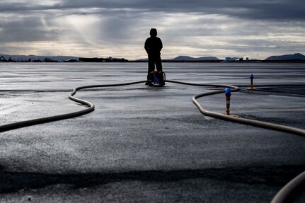 Boatswain’s Mate Seaman Stanton Smith, a native of Oakhills, California, assigned to Navy Cargo Handling Battalion (NCHB) 1, checks the fuel meter during a fixed wing refueling operation.