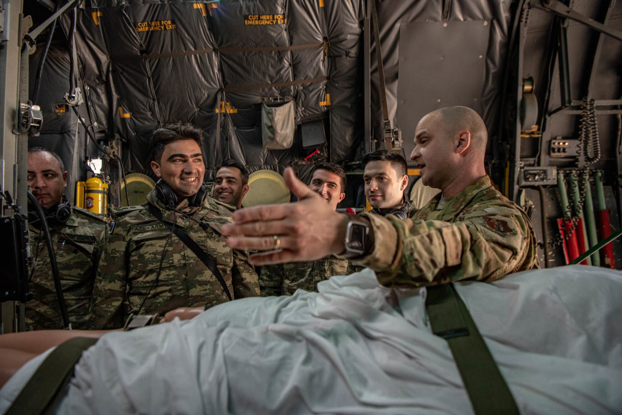 U.S. Air Force Lt. Col. Christopher Lane, director of operations for the 137th Aeromedical Evacuation Squadron, speaks to doctors with the Azerbaijan Operational Capabilities Concept Battalion about aeromedical evacuation roles during a medical knowledge exchange event in Oklahoma City March 30, 2022. The knowledge exchange involved the participation and support of Guardsmen with both the Oklahoma Army and Air National Guard in support of the State Partnership Program.