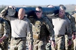 Special Warfare Airmen and leaders participate in the Special Warfare Training Wing and subordinate echelons rededication ceremony in honor of U.S. Air Force Lt. Col. William Schroeder and U.S. Air Force Staff Sgt. Scott Sather at the SWTW training compound Joint Base San Antonio, Chapman Training Annex, Apr. 8, 2022. The wing hosted a two and one-half mile ruck march followed by Memorial pushups and the unveiling of refitted memorials in coordination with Gold Star families.  (U.S. Air Force photo by Brian Boisvert)