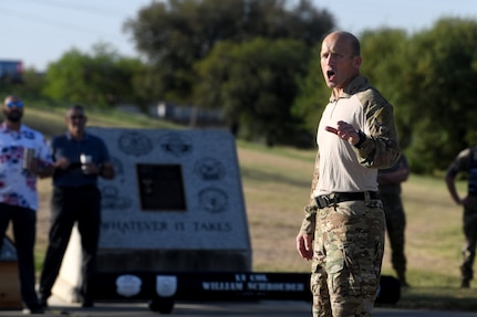 U.S. Air Force Col. Mason Dula, Special Warfare Training Wing commander, gives a final motivational speech following a two and one-half mile ruck march in during a rededication ceremony in honor of U.S. Air Force Lt. Col. William Schroeder and U.S. Air Force Staff Sgt. Scott Sather at the SWTW training compound Joint Base San Antonio, Chapman Training Annex, Apr. 8, 2022.  The wing and echelon units hosted a two and one-half mile ruck march followed by Memorial pushups and the unveiling of refitted memorials in coordination with Gold Star families (U.S. Air Force photo by Brian Boisvert)