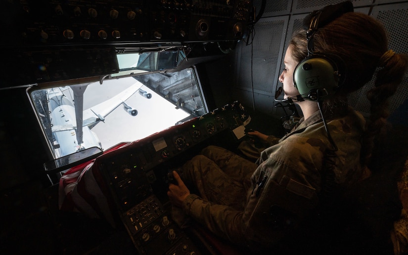 U.S. Air Force Airman 1st Class Lauren Hotaling, 908th Expeditionary Air Refueling Squadron in-flight refueling specialist, refuels an E-3 Sentry over the U.S. Central Command area of responsibility, April 7, 2022. The refueling sortie marked the last deployed KC-10 Extender flight flown by a crew deployed from McGuire Air Force Base, New Jersey.  McGuire AFB will cease their KC-10 deployments as the base is transitioning to fly the KC-46 Pegasus. (U.S. Air Force photo by Senior Airman Jacob B. Wrightsman)