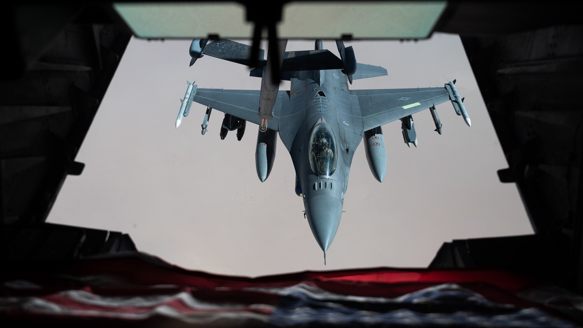 A U.S. Air Force F-16 Fighting Falcon is refueled by a KC-10 Extender over the U.S. Central Command area of responsibility, April 7, 2022. The KC-10 is an advanced tanker and cargo aircraft designed to provide increased global mobility for U.S. armed forces. (U.S. Air Force photo by Senior Airman Jacob B. Wrightsman)