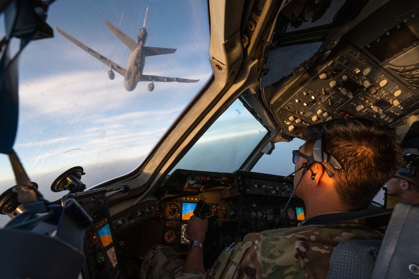 U.S. Air Force Capt. Kevin Cabusora, 908th Expeditionary Air Refueling Squadron KC-10 Extender aircraft commander and Capt. Gavin Owens 908th EARS instructor pilot, connect to another KC-10 for aerial refueling over the U.S. Central Command area of responsibility, April 7, 2022. The sortie marked the last KC-10 flight flown by a crew deployed from McGuire Air Force Base, New Jersey. McGuire AFB will cease KC-10 deployments as the base is transitioning to fly the KC-46 Pegasus. (U.S. Air Force photo by Senior Airman Jacob B. Wrightsman)