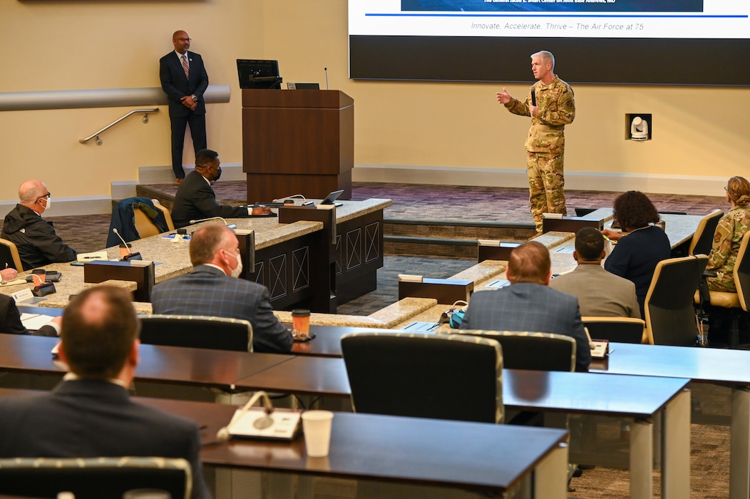 Man in uniform speaks onstage at conference