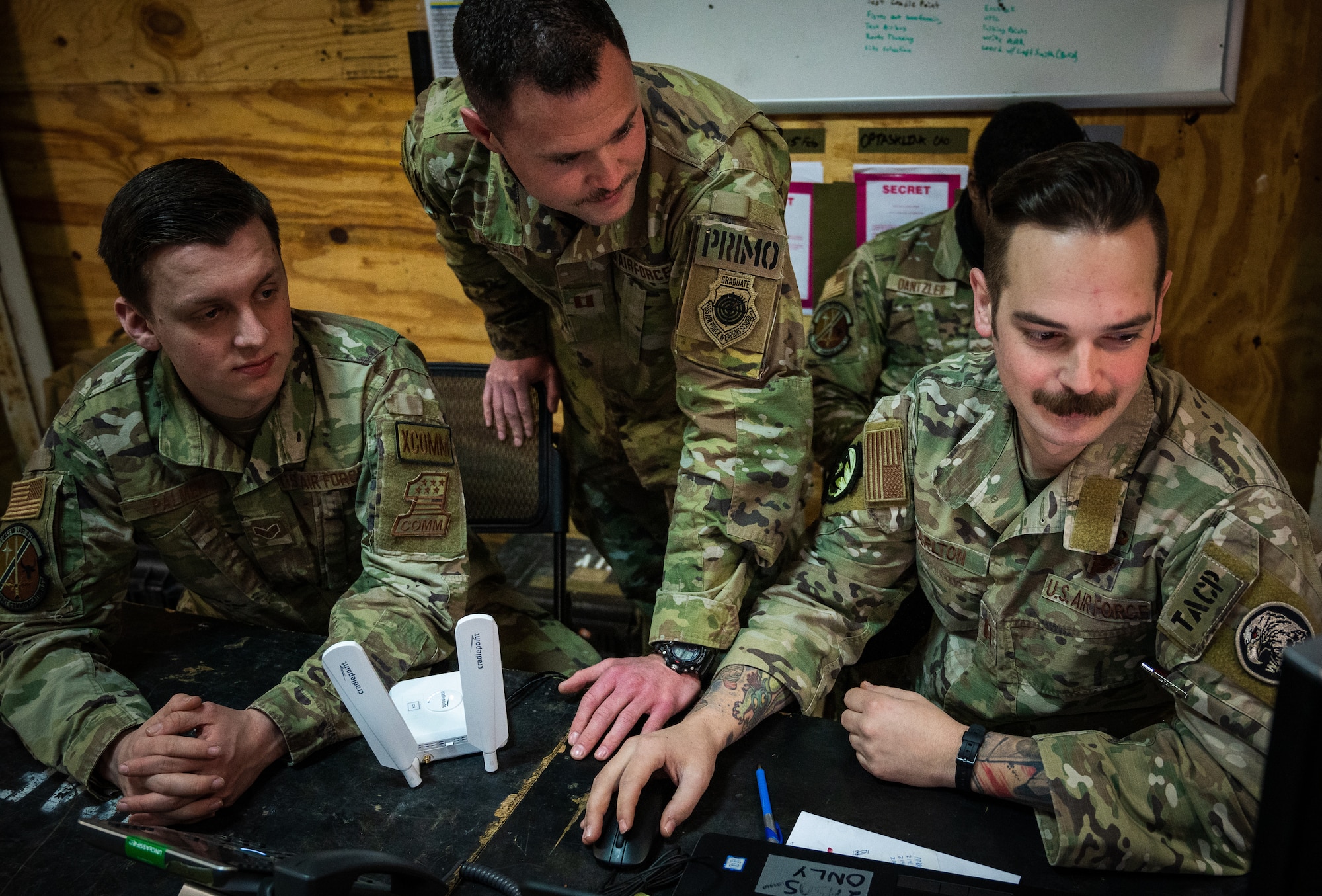 A U.S. Air Force Tactical Air Control Party Team Leader, from the 4th Air Support Operations Group, works alongside Airmen, assigned to the 606th Air Control Squadron and the 1st Combat Communications Squadron, to develop products for air space coordination and control in Romania, March 6, 2022.