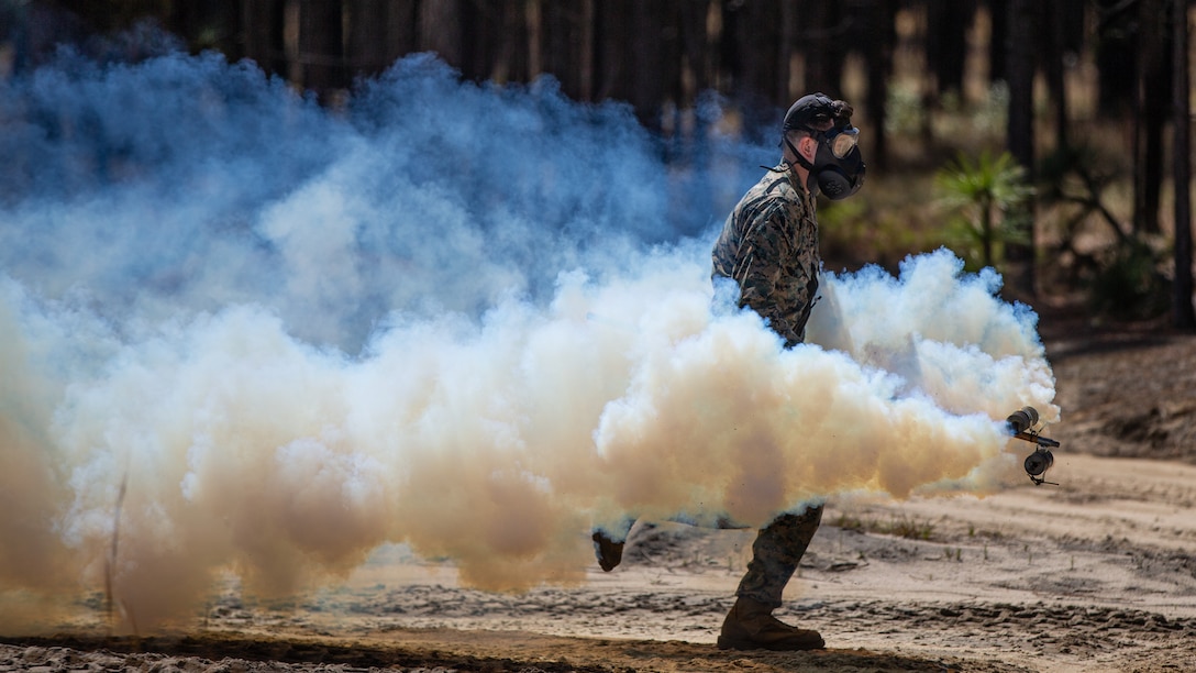 U.S. Marine Corps Lance Cpl. Mark McCabe, a Lakeland, Florida, native and chemical, biological, radiological, and nuclear defense specialist with 2nd Battalion, 10th Marine Regiment, 2nd Marine Division, conducts a tear gas raid during Exercise Rolling Thunder 22-2 on Fort Bragg, N.C., April 8, 2022. This exercise is a 10th Marines-led live-fire artillery event that tested the unit’s abilities to operate in a simulated littoral environment against a peer threat in a dynamic and multi-domain scenario.