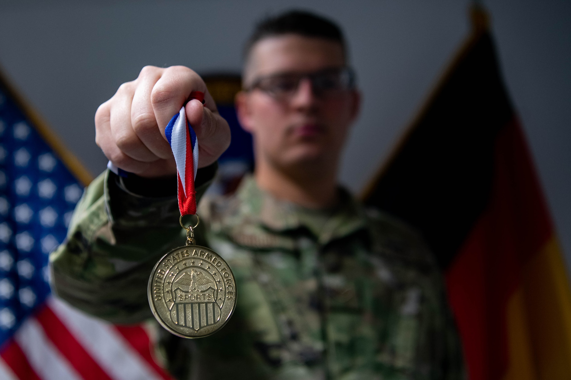 Airman holds medal.