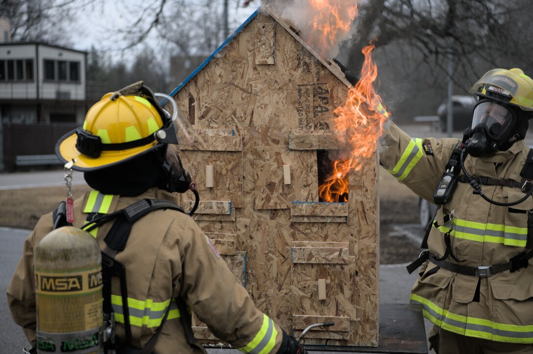 Firefighters from Alpena Combat Readiness Training Center demonstrated the use of live-fire training props at Alpena Combat Readiness Training Center, Alpena, Mich. April 07, 2022. The props, known as “Palmer’s Dollhouses,” are utilized by fire departments nationwide to train critical skills including communication, smoke reading (color, velocity, density and volume), ventilation tactics, and thermal imaging camera operations. (U.S. Air National Guard photo by Staff Sgt. Jacob Cessna)