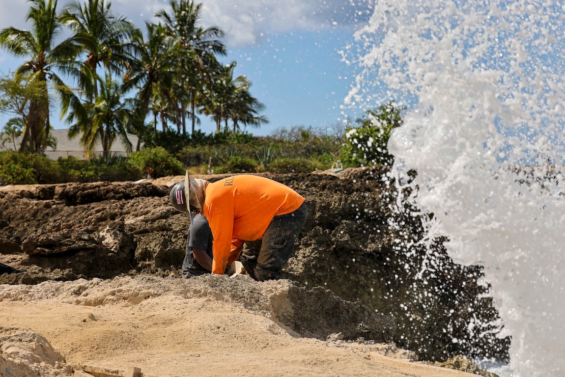 Naval Sea Systems Command (NAVSEA) contractors mold concrete during the final phase of an equipment removal project at Nanakuli Beach Park.