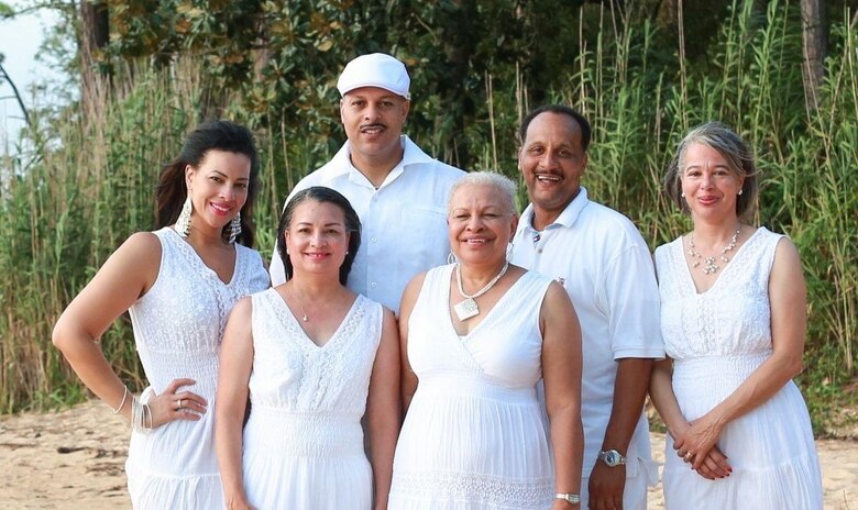 Lita Trotter, second from left, poses for a family portrait with her sister Essina, far left, mother Clara, immediate right, brother George, behind center, brother Nikklos, right, and sister Cassandra, far right. Trotter has worked with USACE for 27 years, 24 of those in the Mobile District